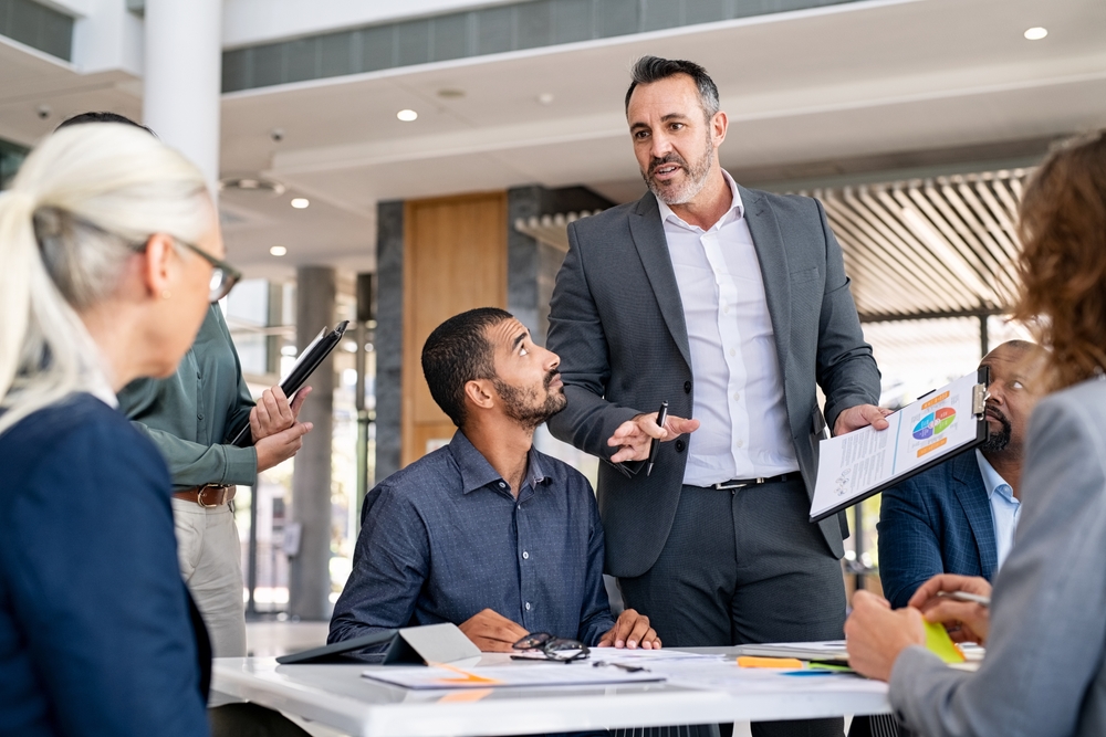 Entrepreneur Focusing On Work With Charts During Meeting